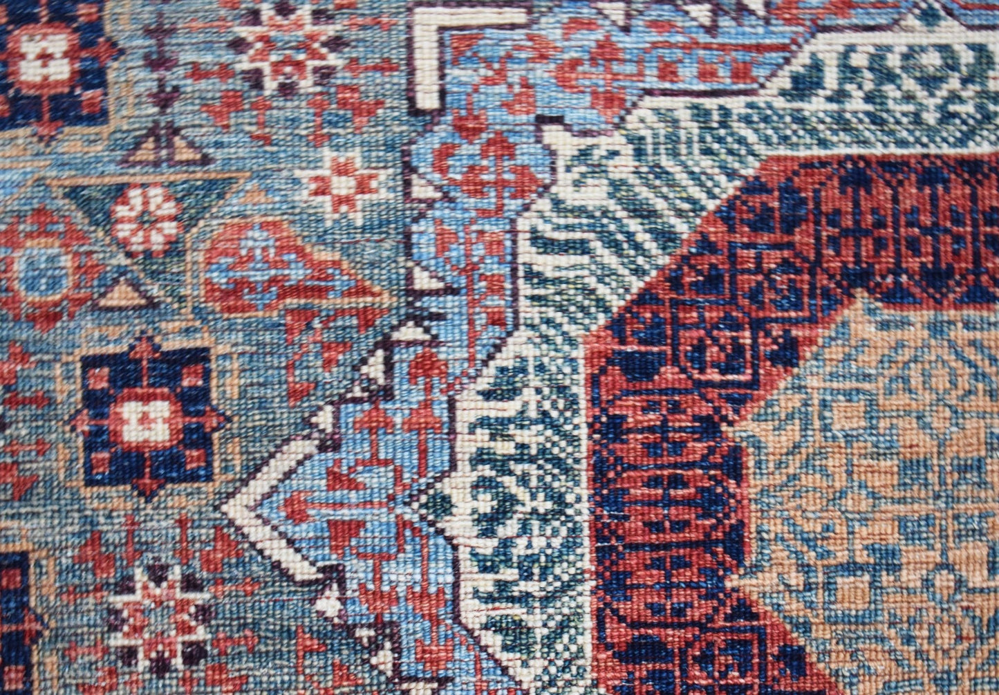 A close-up of a handwoven Afghan Balkh rug featuring a detailed Mamluk pattern in blue and red.