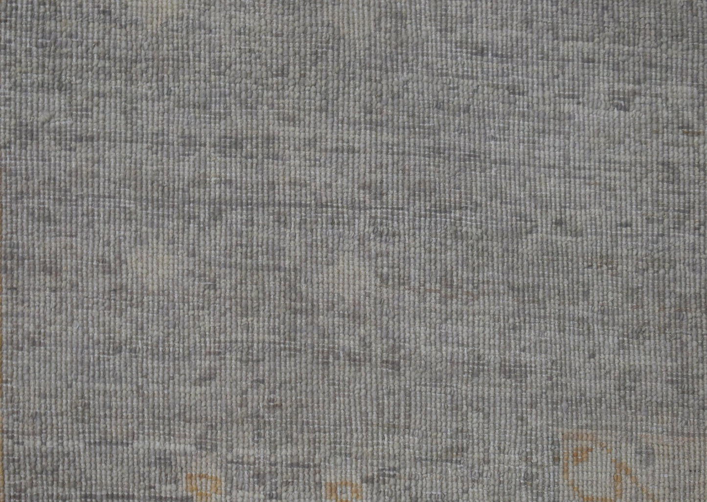 A handwoven Afghan Balkh rug featuring a textured, neutral grey wool pile with subtle variations.