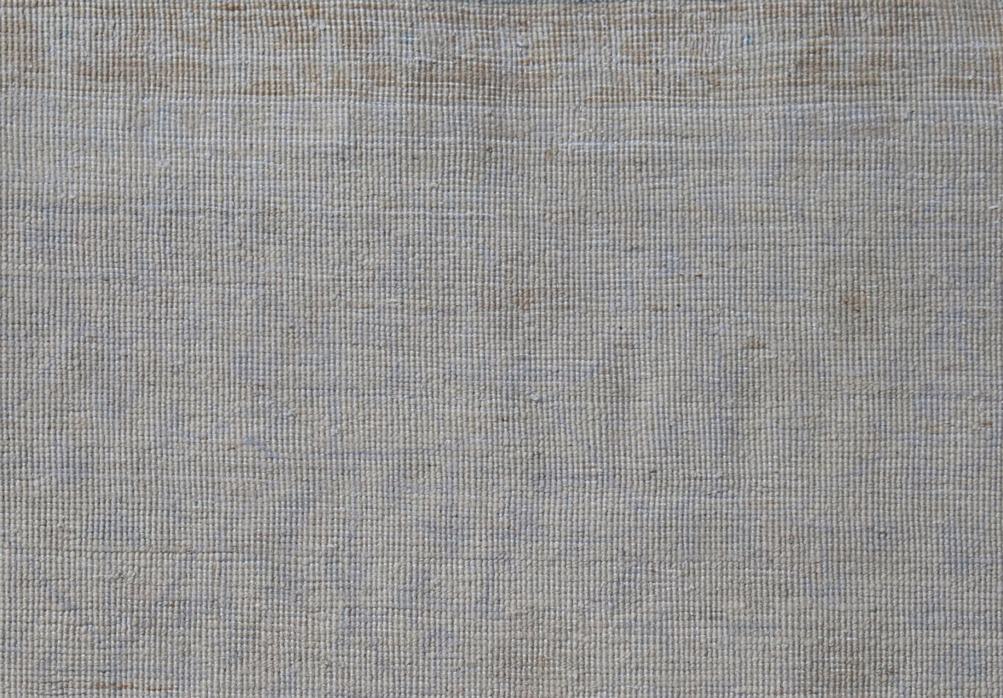 A close-up view of a handwoven Afghan Balkh rug featuring a neutral, textured wool weave.