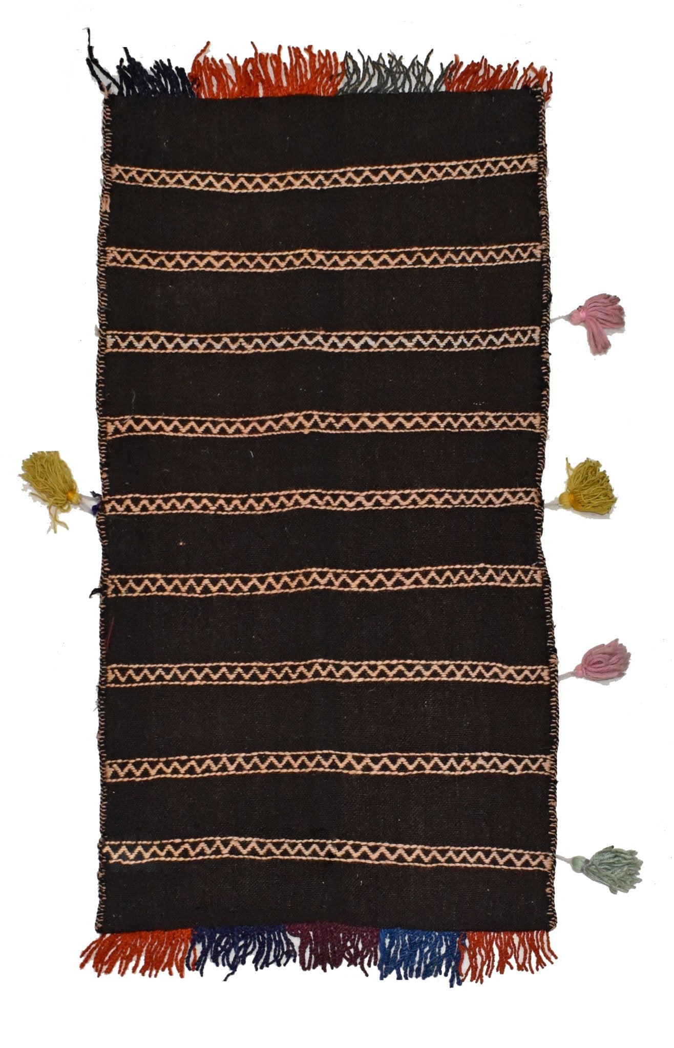 A vintage Afghan saddle bag made of dark wool with horizontal zigzag patterns and side tassels.