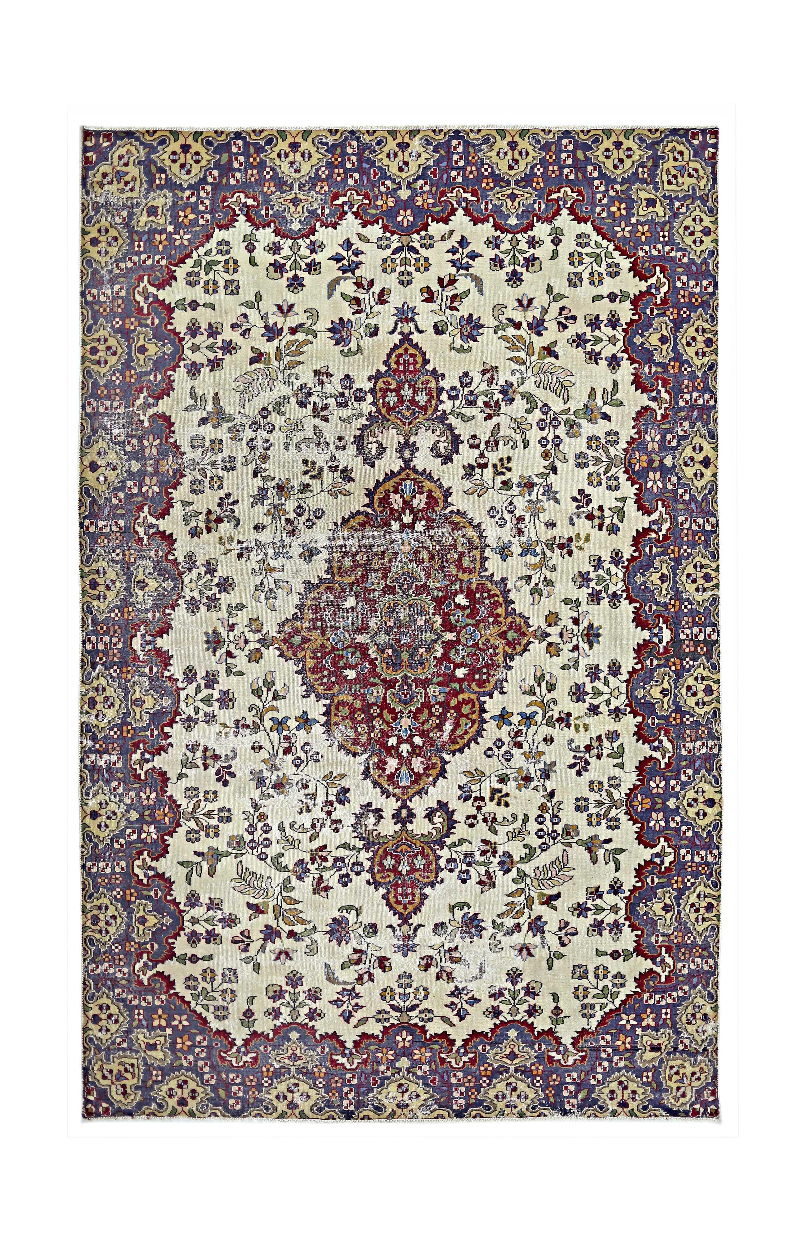 A vintage Persian Kerman rug featuring a central medallion and intricate floral patterns.