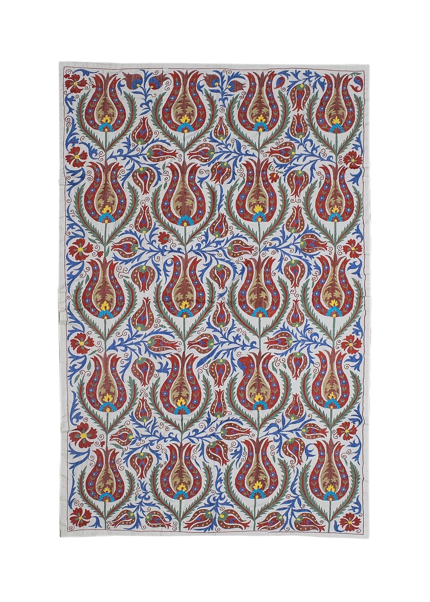A rectangular Uzbek suzani textile featuring intricate floral embroidery in red, blue, and gold.