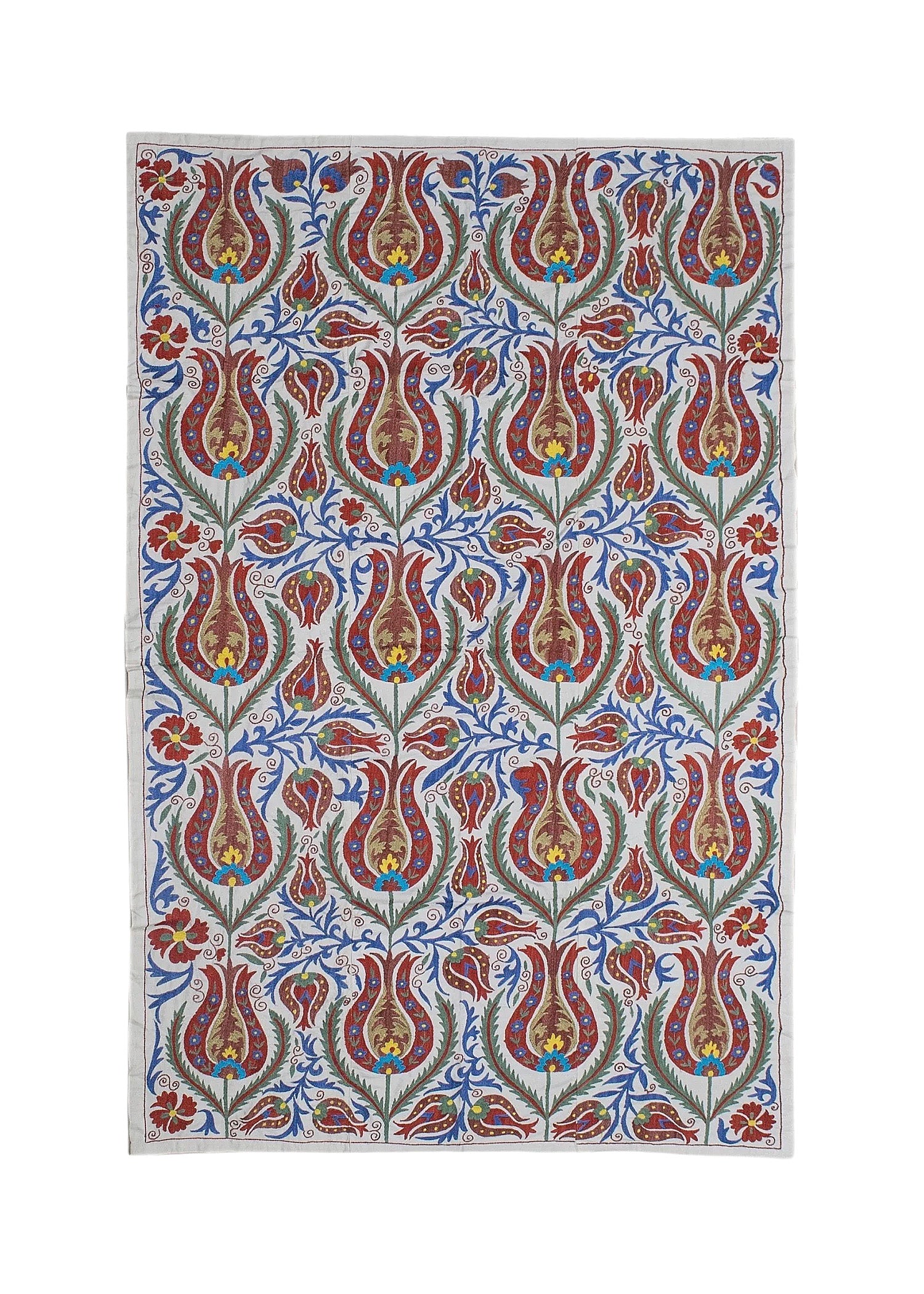 A rectangular Uzbek suzani textile featuring intricate floral embroidery in red, blue, and gold.