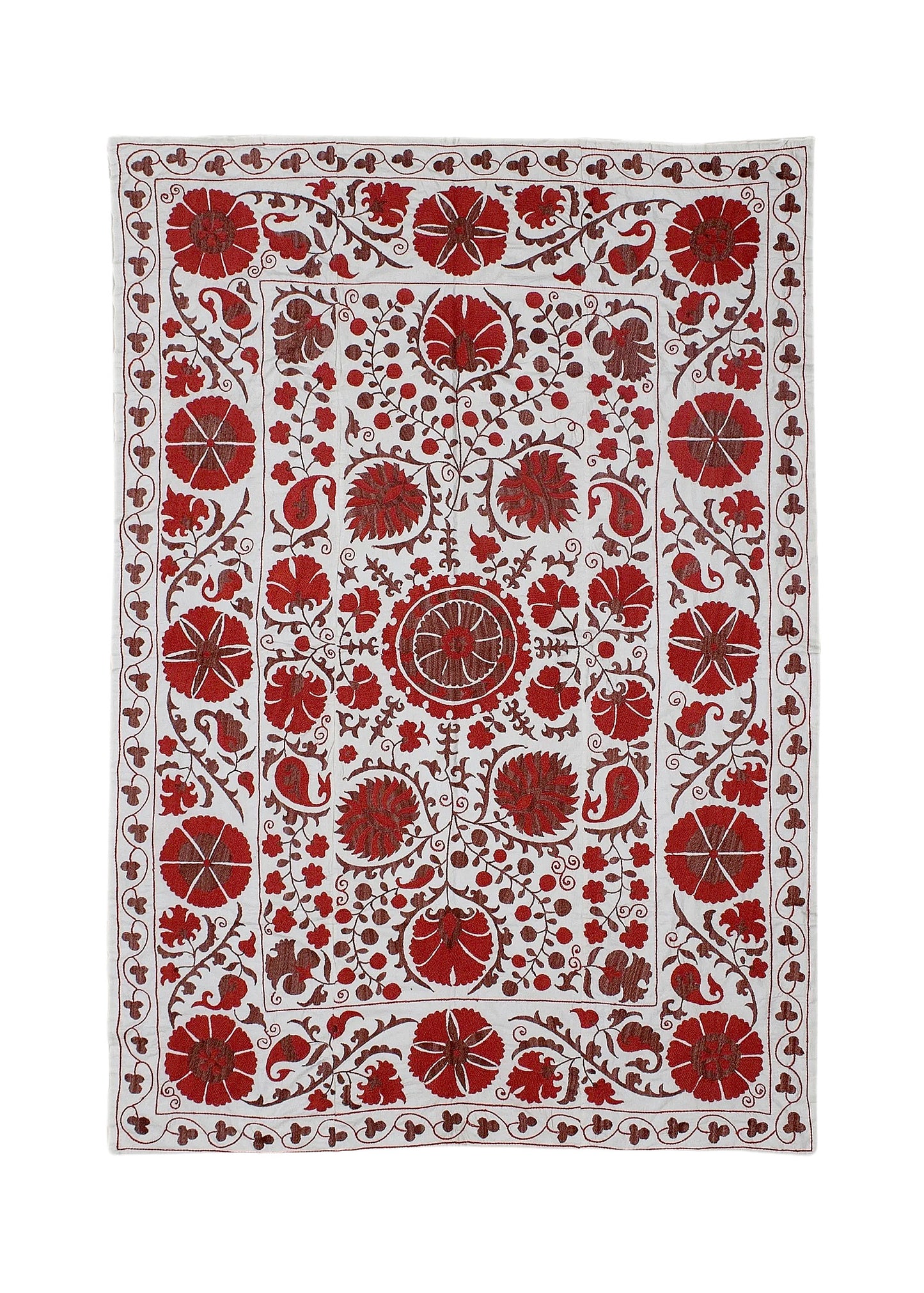 A rectangular Uzbek suzani featuring intricate red floral embroidery on a white cotton background.