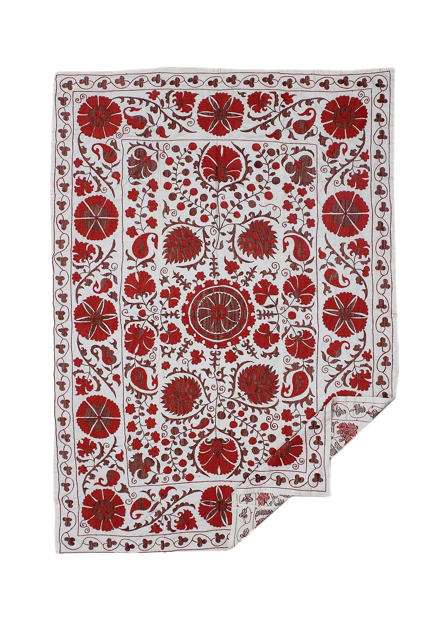 A rectangular Uzbek suzani featuring intricate red floral embroidery on a white cotton background.