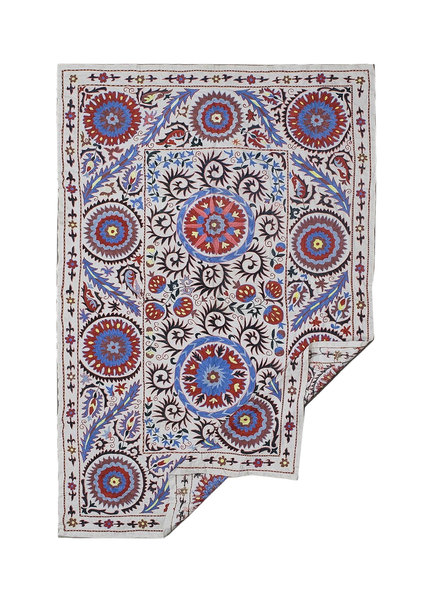 A rectangular Uzbek suzani featuring hand-embroidered floral and circular motifs on a cotton base.