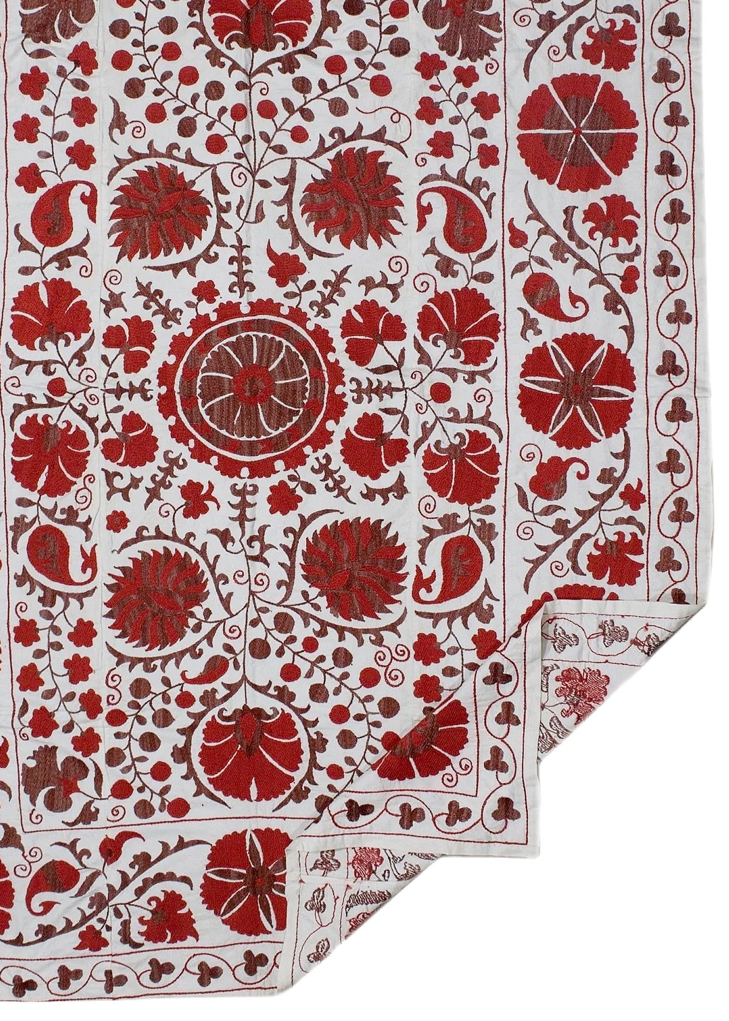A white cotton textile featuring intricate red floral and paisley embroidery in a traditional style.