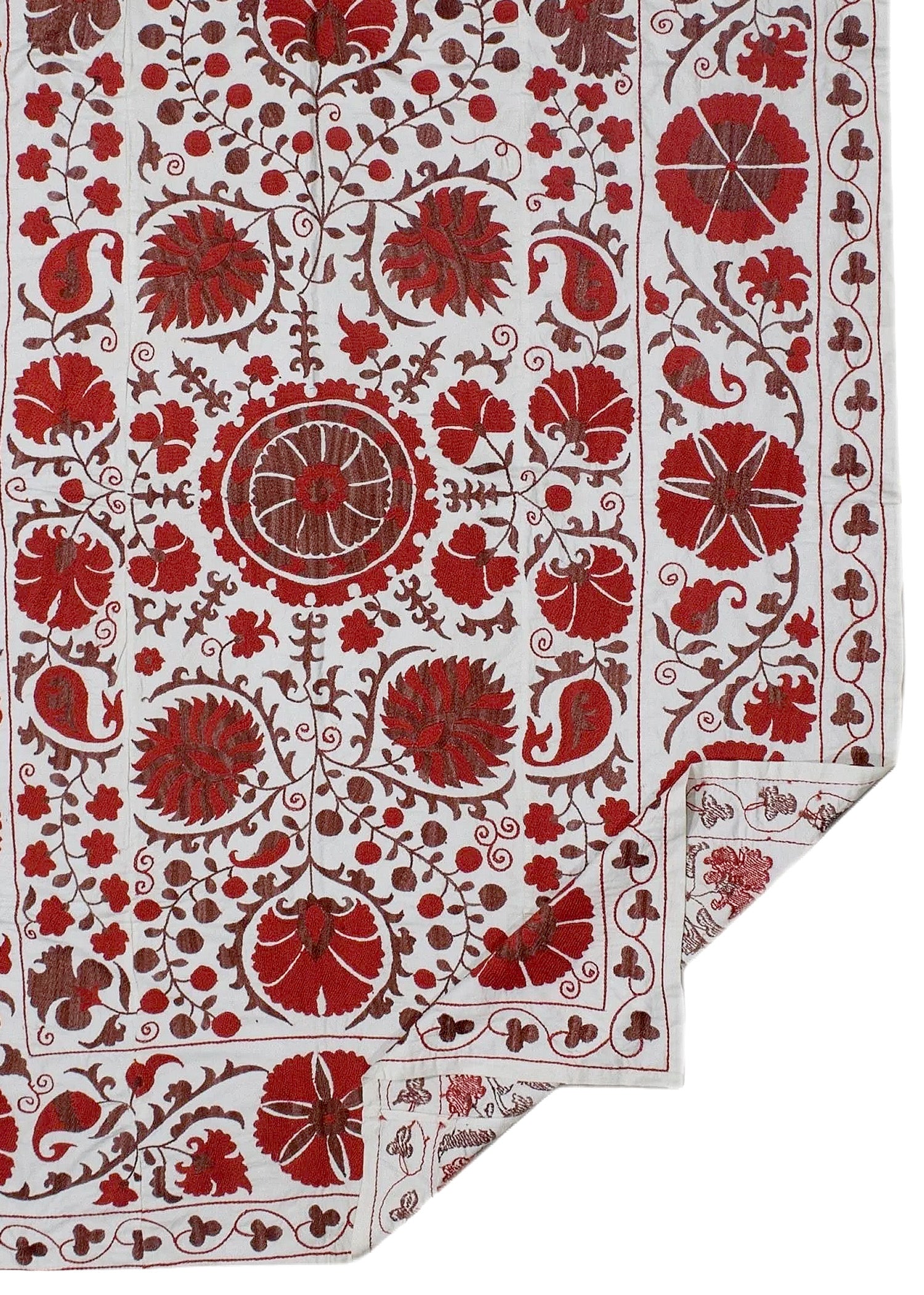 A white cotton textile featuring intricate red floral and paisley embroidery in a traditional style.