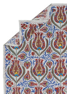 Hand-embroidered Uzbek Suzani textile featuring a vibrant floral pattern on a white cotton base.