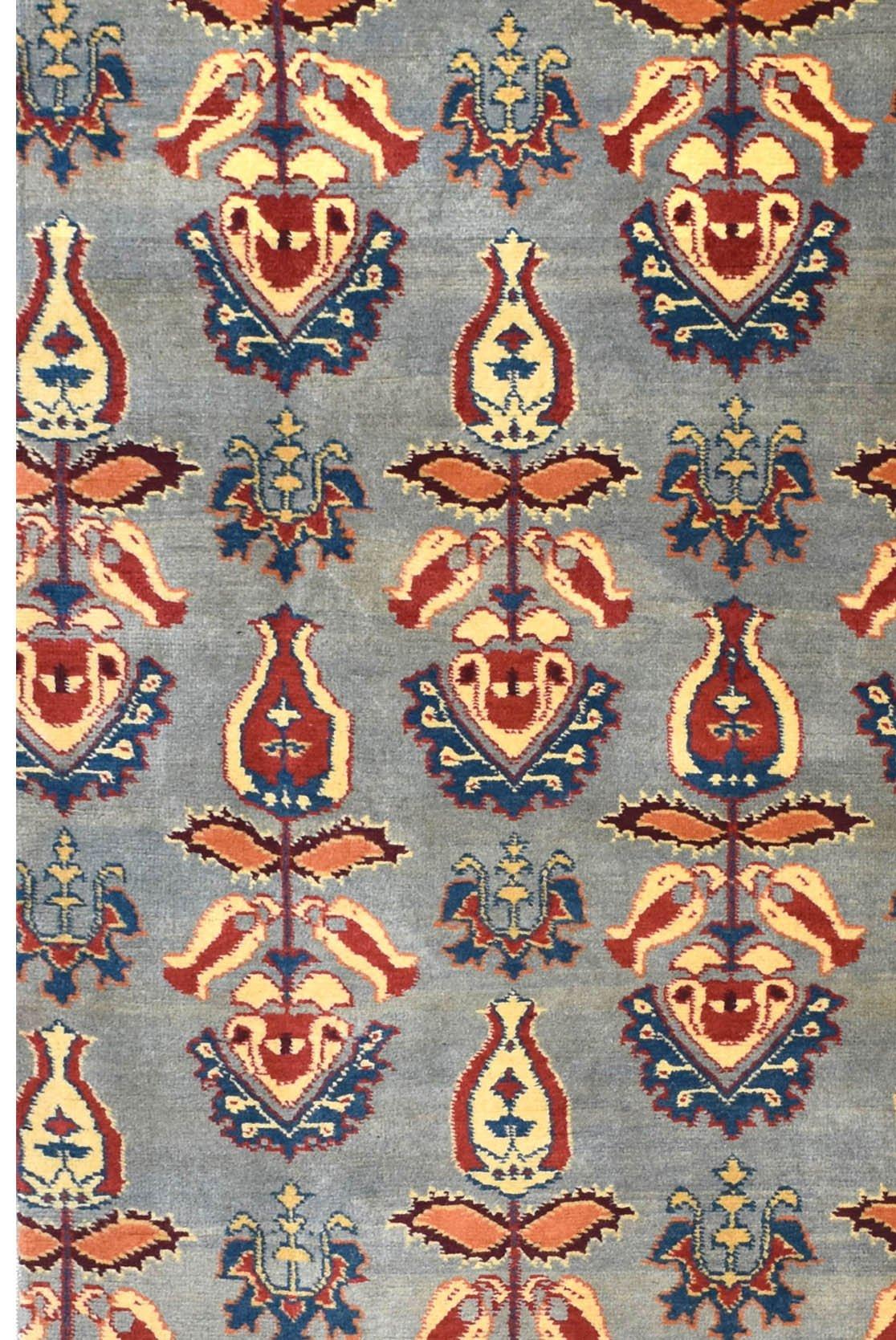 An Afghan Chobi runner featuring a repeating floral motif in red, blue, and cream on a grey field.