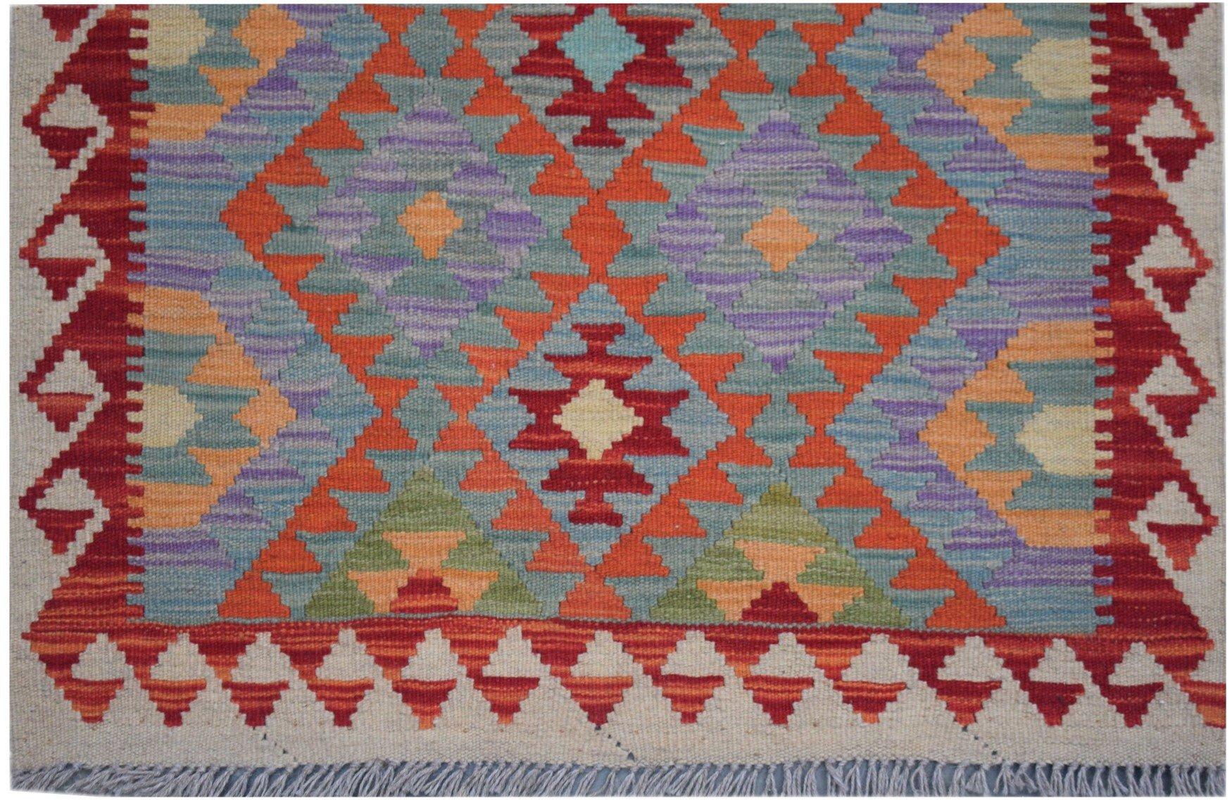 Handmade Afghan Maimana kilim runner featuring a vibrant geometric pattern in wool.