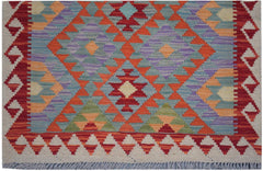 Handmade Afghan Maimana kilim runner featuring a vibrant geometric pattern in wool.