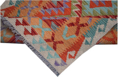 A handmade Afghan Maimana kilim runner featuring vibrant geometric patterns in wool.