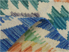 A handmade Afghan Maimana kilim runner featuring a colorful geometric pattern on a wool base.