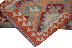 A handmade Afghan Maimana kilim runner featuring vibrant geometric patterns in wool.
