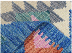 A close-up view of a handmade Afghan Maimana kilim runner featuring colorful geometric patterns.