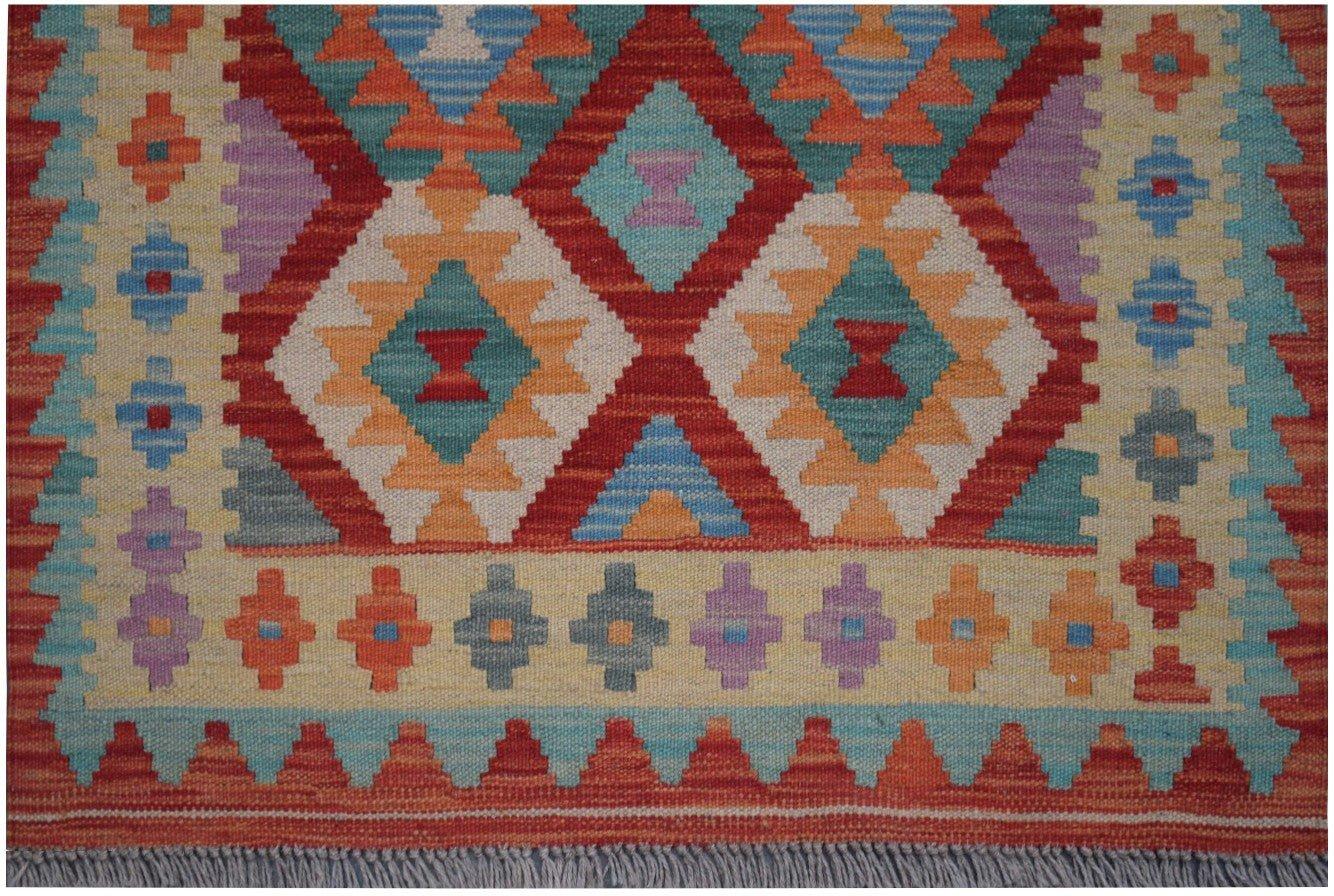 Handmade Afghan Maimana kilim runner featuring a colorful geometric pattern on a wool base.