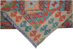 A handmade Afghan Maimana kilim runner featuring geometric patterns in orange, blue, and green.