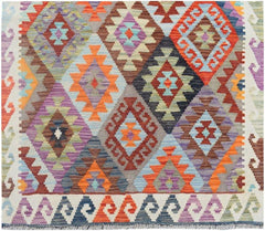 Handmade Afghan Maimana wool runner rug featuring a colorful geometric diamond pattern.