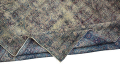 An antique Persian Kerman rug featuring a detailed floral medallion pattern in blue and red tones.