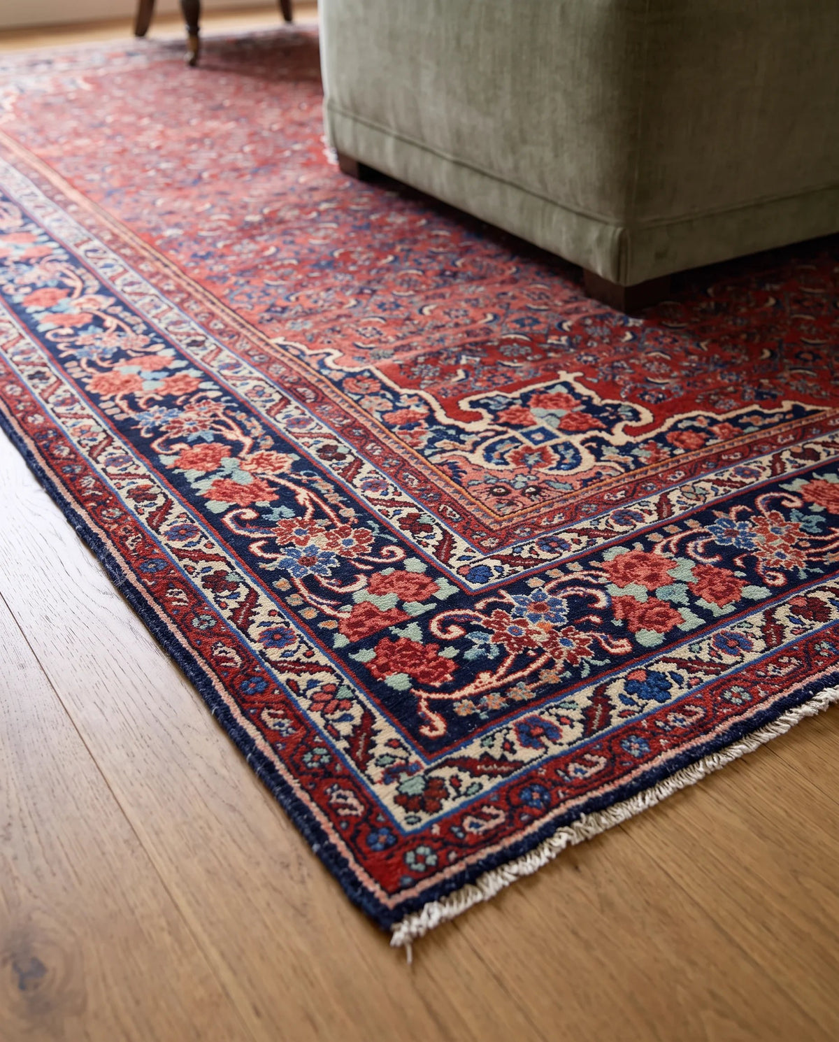 Vintage Persian Bidjar rug with intricate red and blue floral patterns, featuring a dense wool weave and short fringe.