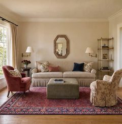 Vintage Persian Bidjar rug with intricate red and blue floral patterns styled in a traditional living room.