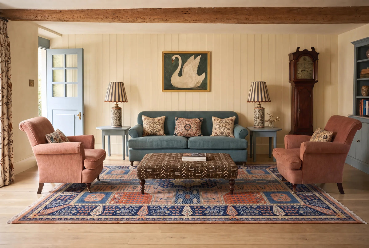 Hand-knotted Afghan Balkh rug with intricate blue and terracotta geometric patterns in a traditional living room.