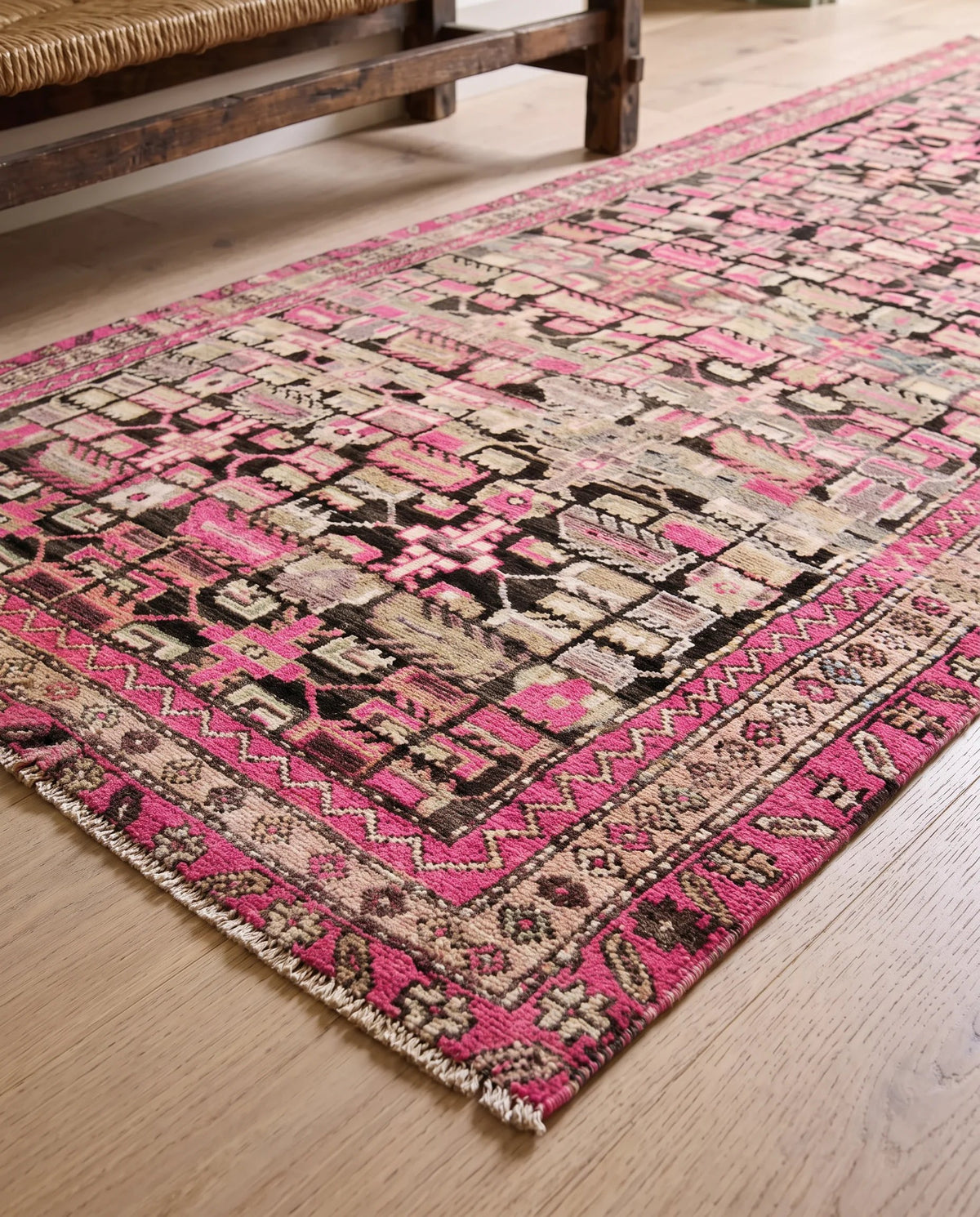 Vintage Persian Ardabil wool runner featuring a geometric pink, black, and cream pattern with a fringed edge.