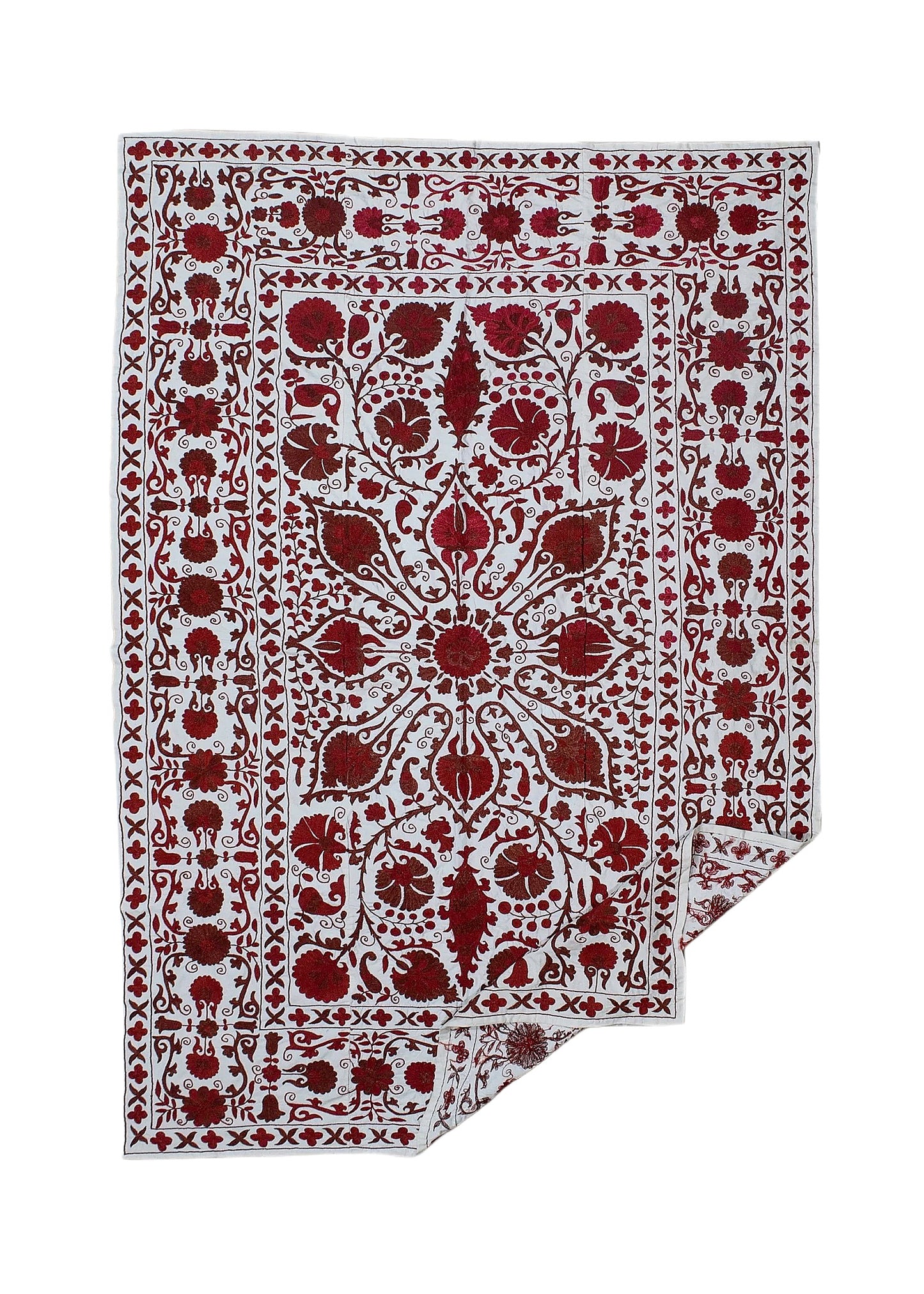 A white cotton textile featuring intricate red floral and leaf embroidery in a traditional pattern.
