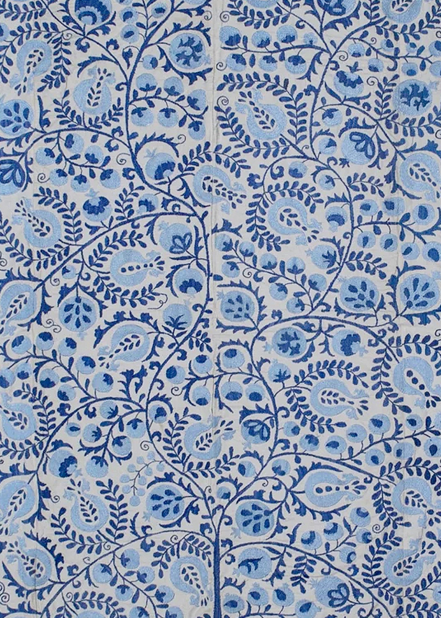 Hand-embroidered Uzbek Suzani textile featuring intricate blue floral and pomegranate motifs.