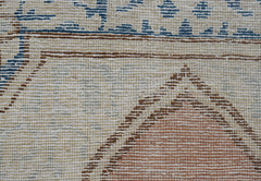 A close-up of a vintage Persian Kerman runner featuring intricate floral and geometric patterns.