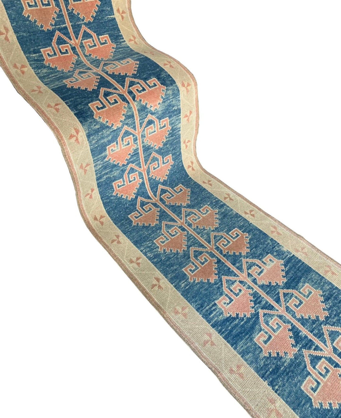 A vintage Turkish Oushak runner featuring a blue field with pink tribal motifs and a cream border.