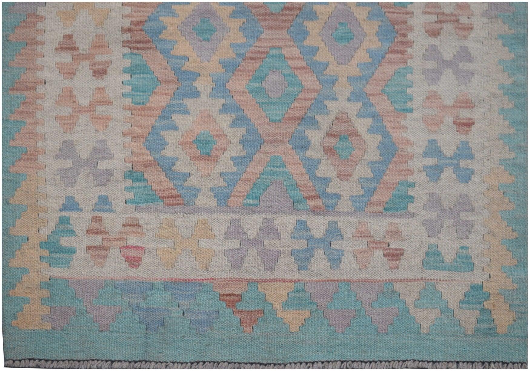 Handmade Afghan Maimana kilim runner featuring a geometric pattern in soft blue, pink, and tan.