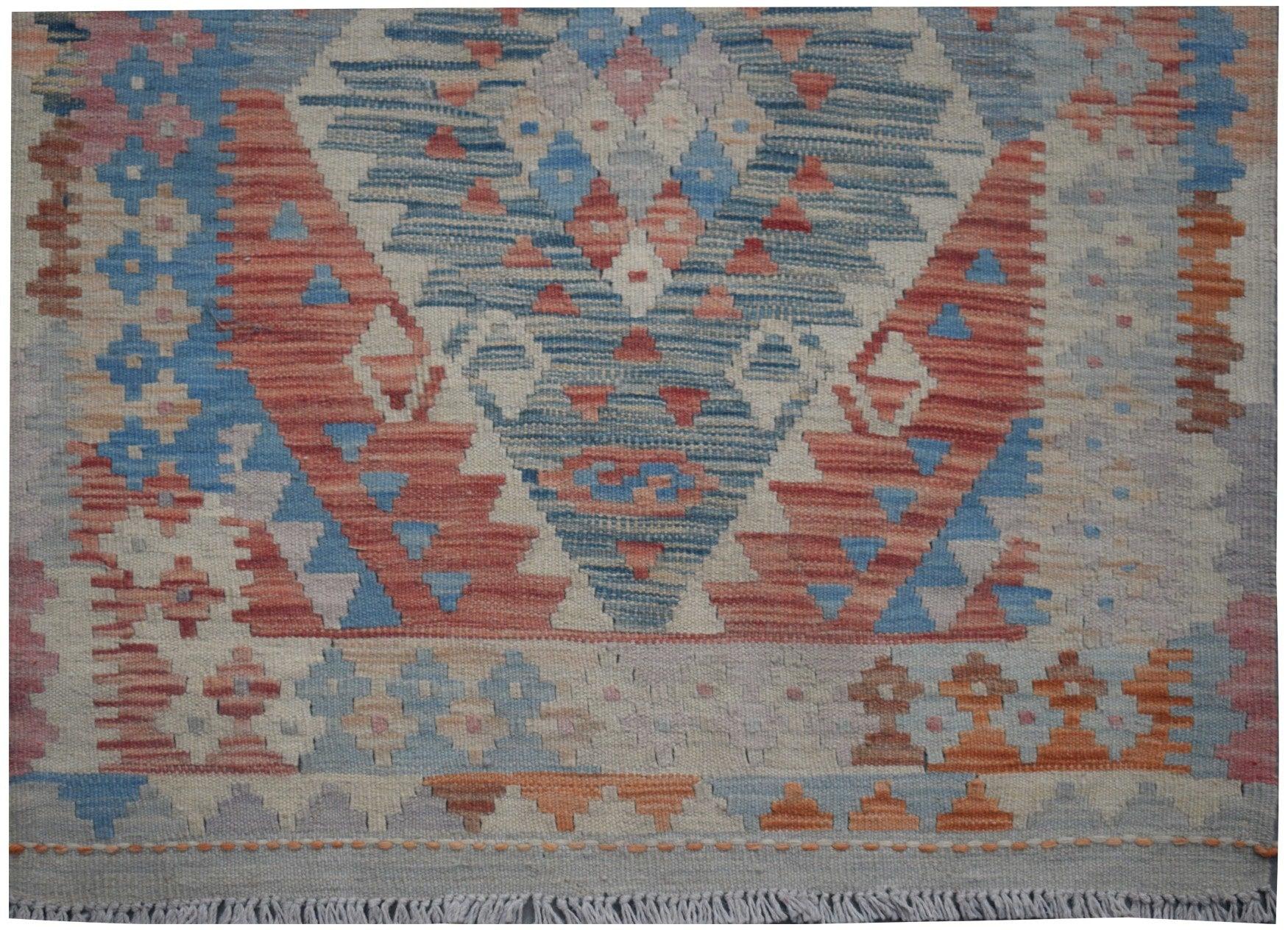 Handmade Afghan Maimana kilim runner featuring a geometric pattern in blue, red, and cream tones.