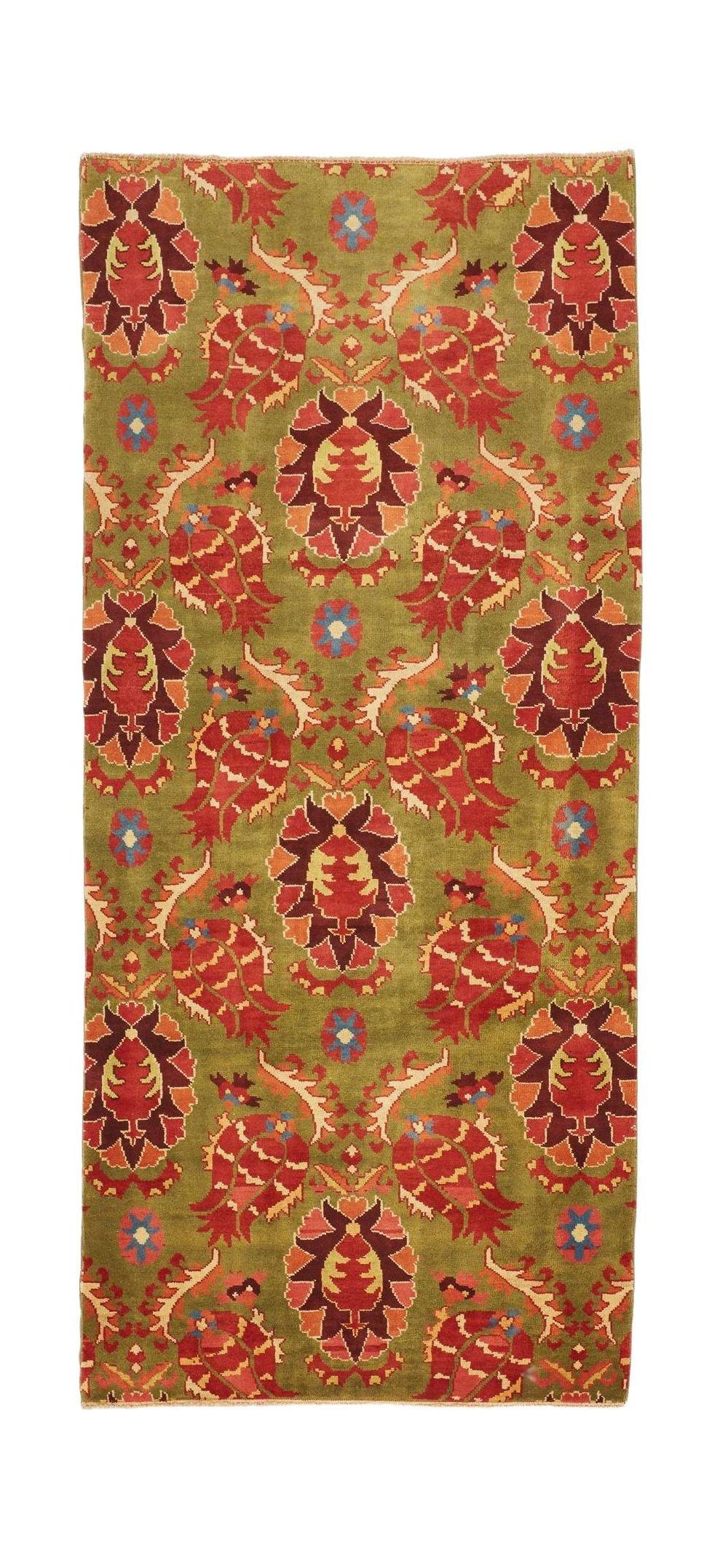 An Afghan Chobi runner rug featuring a repeating floral pattern in red and orange on a green field.