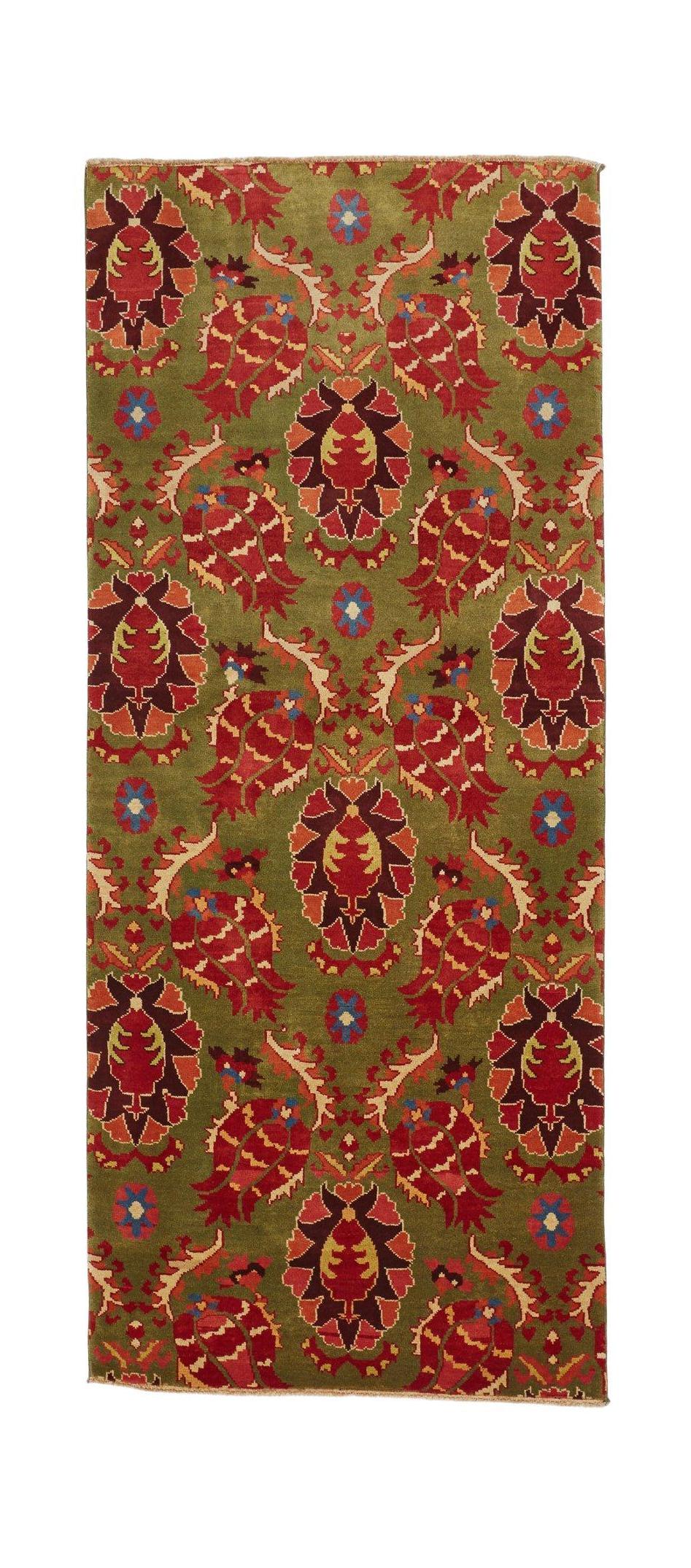 An Afghan Chobi runner rug featuring a repeating floral pattern in red and green wool.