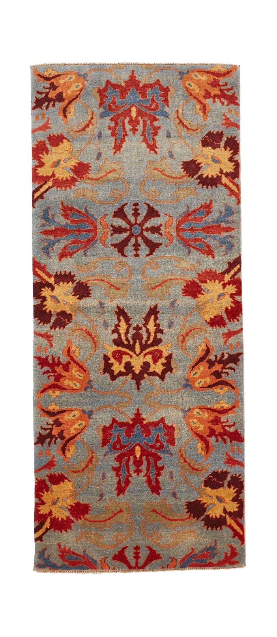 An Afghan Chobi runner rug featuring a blue field with intricate red and orange floral motifs.