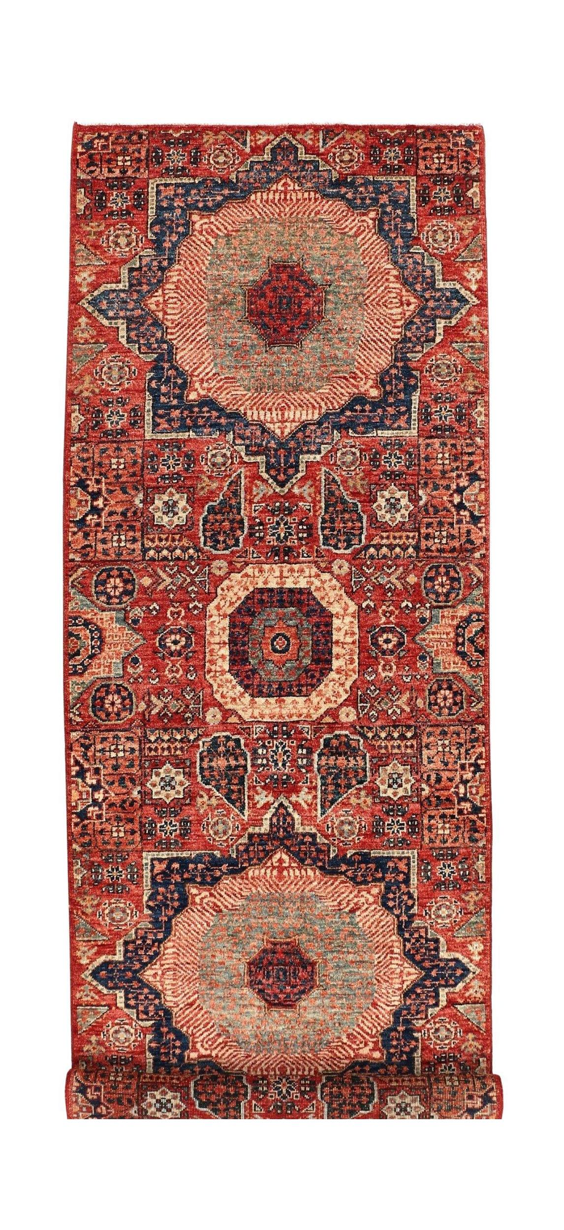 A handmade Afghan Chobi runner rug featuring a traditional red Mamluk medallion design.