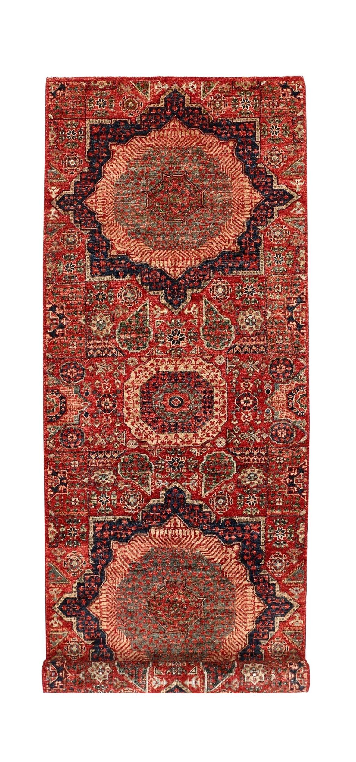 A handmade Afghan Chobi runner rug featuring intricate Mamluk medallions in red and navy blue.