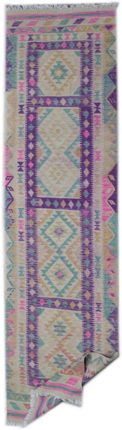 Handmade Afghan Maimana wool runner rug featuring a geometric pattern in purple, pink, and teal.