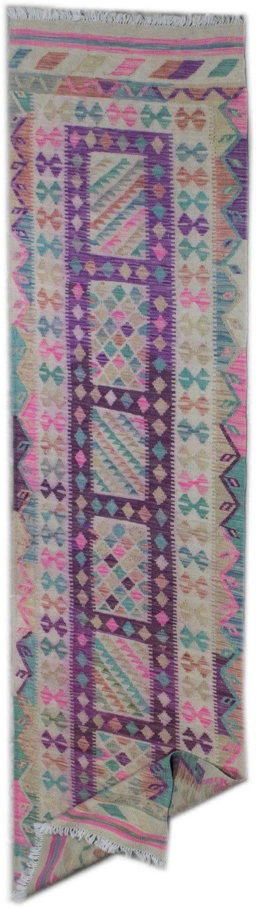 Handmade Afghan Maimana wool runner rug featuring a vibrant geometric pattern in purple and pink.