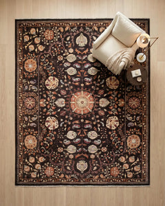 Hand-knotted Afghan Chobi rug with a dark brown Suzani floral pattern and cream fringe, styled in a room.