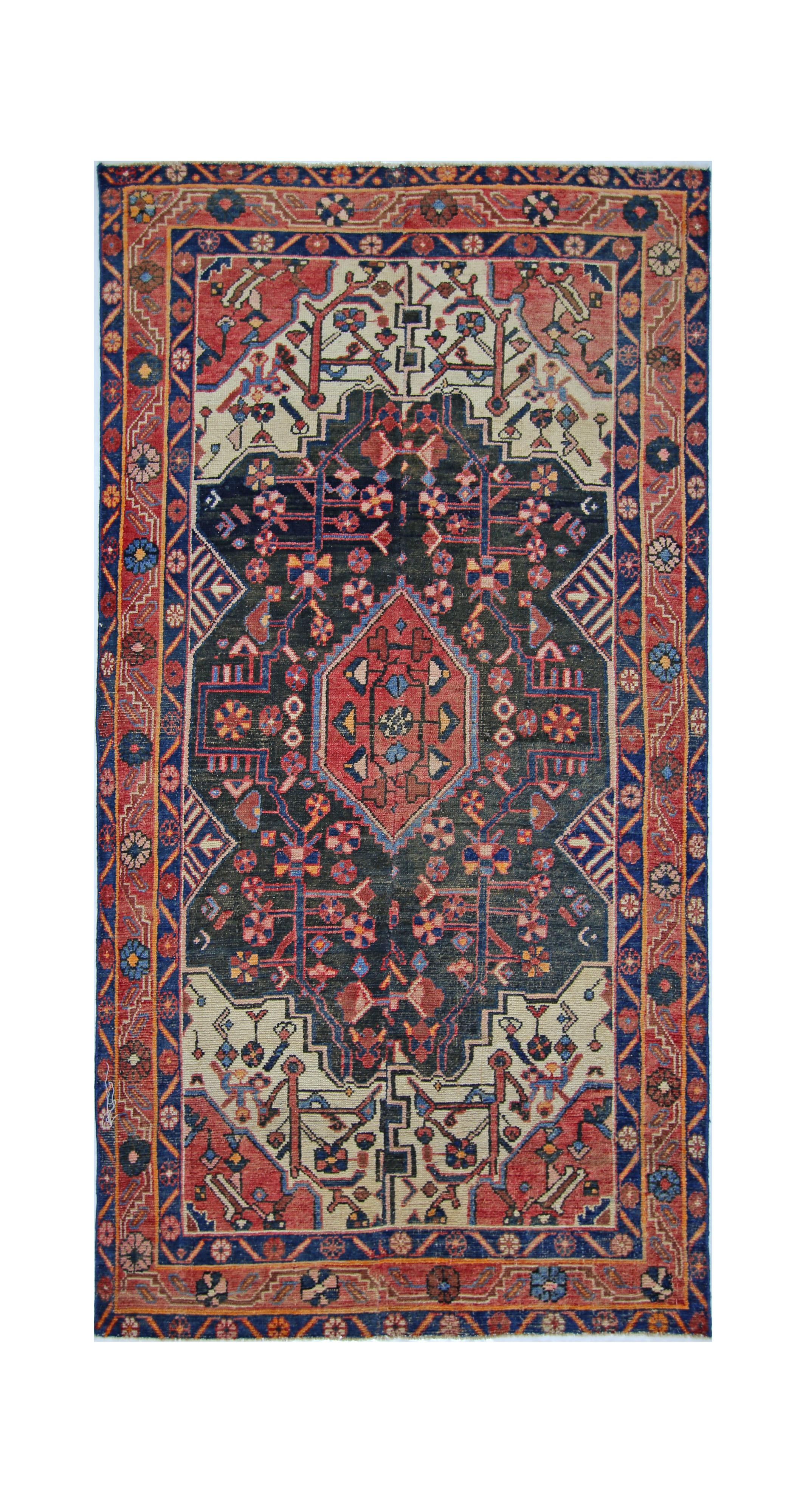 A vintage handmade Persian rug featuring a central diamond medallion on a dark blue field.