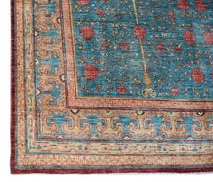 A handwoven Afghan Balkh rug featuring a blue field with pomegranate motifs and ornate borders.