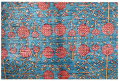 Handwoven Afghan rug featuring a repeating pomegranate motif in red on a blue background.