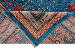 A handwoven Afghan Balkh rug featuring a vibrant blue field with red floral patterns and borders.