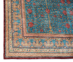 A handmade Afghan Balkh rug featuring a blue field with a pomegranate tree motif and ornate borders.