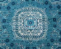 A handmade Afghan Mamluk rug featuring an intricate blue and white geometric medallion pattern.