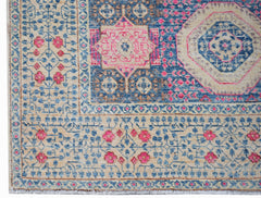 A handwoven Afghan Mamluk rug featuring a detailed geometric medallion in blue, pink, and beige.