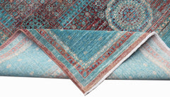 A handmade Afghan Balkh rug with a Mamluk pattern in shades of teal and deep red.